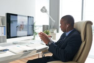 Employee having video conference with coworker