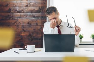 Employer showing frustration in front of laptop.