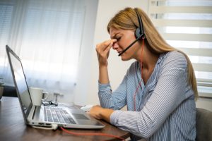 Woman experiencing frustration while working remotely
