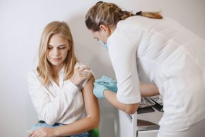 female employee getting vaccine after employer covid vaccine mandate announced